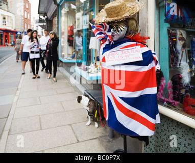 A Union Jack flag for sale, wrapped around a mannequin outside a souvenir shop in the seaside town of Swanage, Dorset. UK. Stock Photo