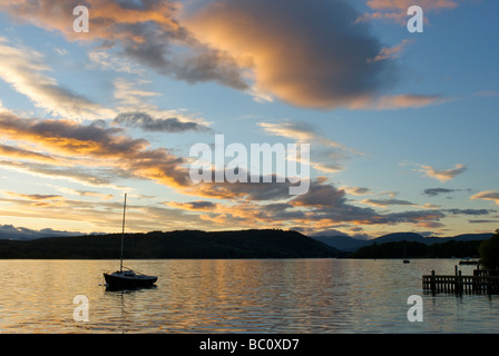 Sailing boat on Lake Windermere after sunset, Lake District National Park, Cumbria, England UK Stock Photo