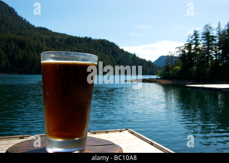 Heaven is an icy cold pint of beer in a chilled glass on a hot sunny day at a Haida Gwaii wilderness fishing resort Stock Photo