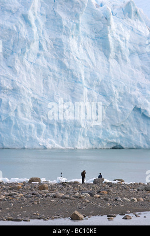 A group of hikers stand at the terminal face of the Perito Moreno Glacier, in Los Glaciares National Park, Patagonia, Argentina. Stock Photo