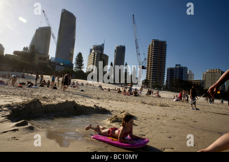 Locals and tourists playing on the beach near sunset Surfer s Paradise Gold Coast Queensland Stock Photo