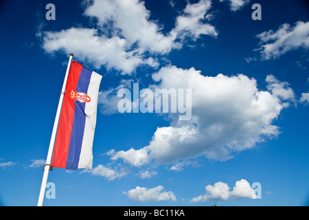 Flag of Serbia under the clouds Stock Photo