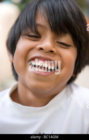 seven year old boy laughing at a friend's joke, closeup Stock Photo