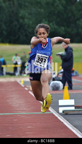 Teenage girl athlete in triple jump Stock Photo