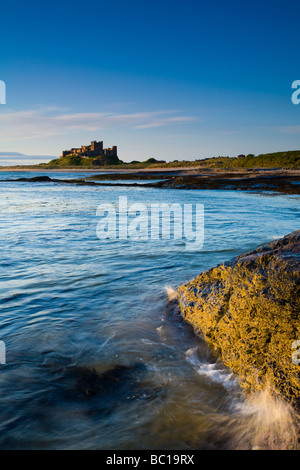 England Northumberland Bamburgh Bamburgh Castle beach and dunes viewed shortly after sunrise from Harkess Rocks Stock Photo