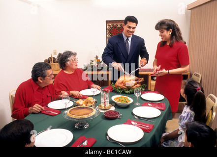 latin hispanic mexican american family holiday dinner thanksgiving christmas meal together tradtion love carve turkey Stock Photo