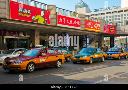 Cabs next to Xidan Shopping center beijing China Stock Photo