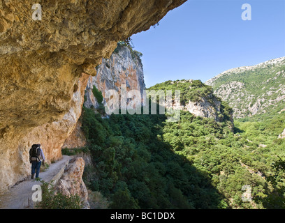 A hiker on a narrow path in the Langadhiotissa gorge between Anavriti and Mystras Lakonia Peloponnese Greece Stock Photo