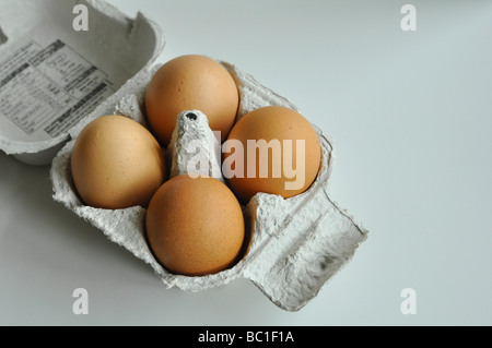 Top View of Four Organic Eggs in a Cardboard Box Stock Photo