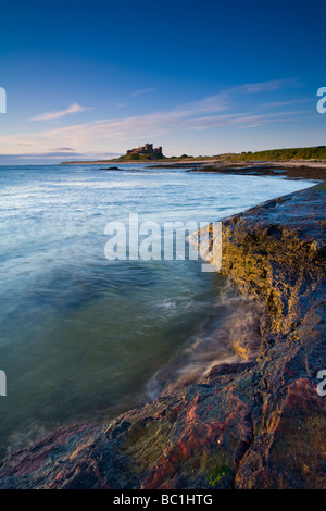 England Northumberland Bamburgh Bamburgh Castle beach and dunes viewed shortly after sunrise from Harkess Rocks Stock Photo