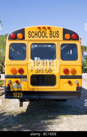 Rear of a yellow school bus with stop sign attached Stock Photo - Alamy