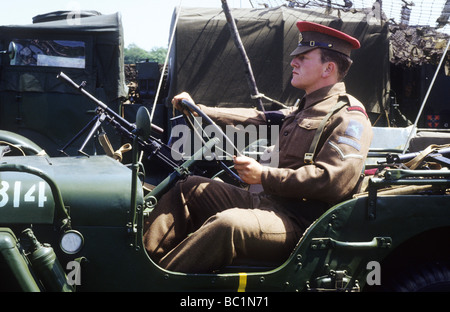 2nd World War historical re-enactment MP Military Policeman driving jeep redcap soldier uniform British Army khaki uniform 1940s Stock Photo