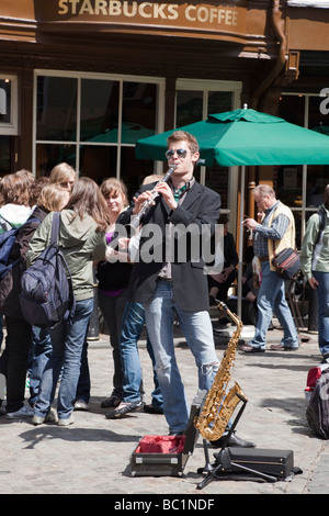 Canterbury Kent England UK Europe Man playing wind instrument busking outside in city centre Stock Photo