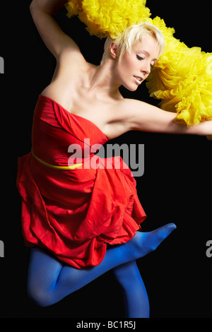Woman dancing against black background Stock Photo