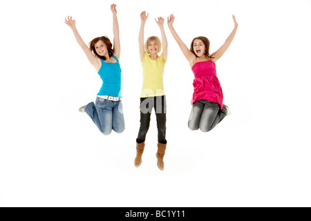 Group Of Three Young Girls Leaping In Air Stock Photo