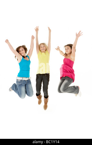 Group Of Three Young Girls Leaping In Air Stock Photo