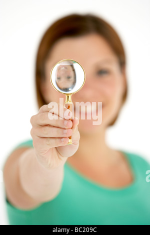 Woman Holding Magnifying Glass Stock Photo