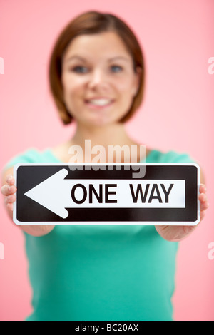 Woman Holding Road Traffic Sign Stock Photo