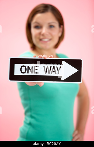 Woman Holding Road Traffic Sign Stock Photo