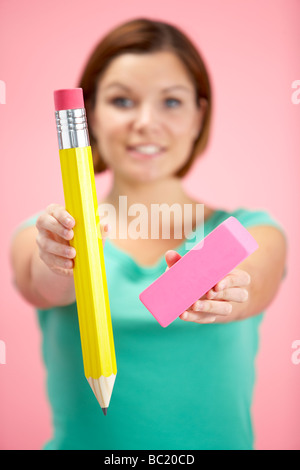 Woman Holding Big Pencil And Eraser Stock Photo