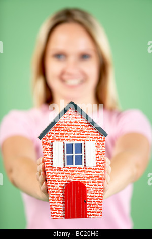 Woman Holding Model House Stock Photo