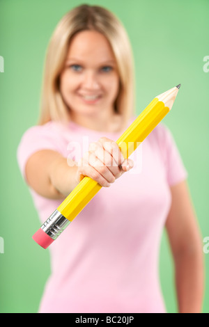 Woman Holding Big Pencil Stock Photo