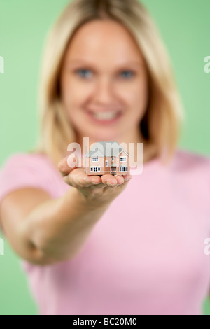 Woman Holding Model House Stock Photo