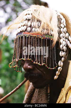 Nandi elder wearing traditional headdress of cowrie shells and a face mask of thin chains Nandi Hills Kenya East Africa Stock Photo