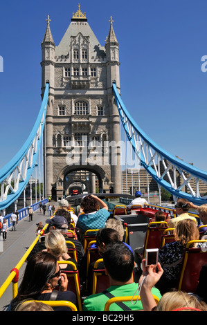 London top deck of open top tour bus passengers taking pictures of Tower Bridge Stock Photo
