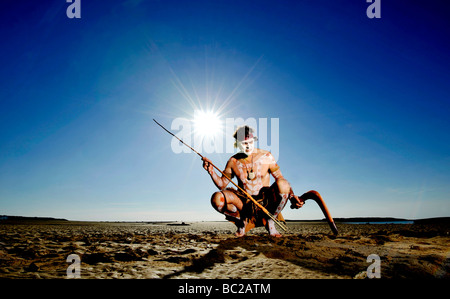 Budawang elder Noel Butler 59 from New South Wales Australia with his boomerang and spear against the blue sky Stock Photo