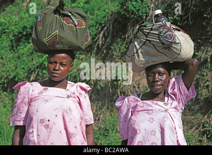 Two Ugandan women with head loads near Kabale South West Uganda East Africa Stock Photo