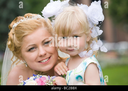 portrait of beautiful bride with little girl Stock Photo