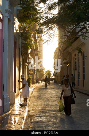 Early morning street scene, Old Havana, Cuba. Washing the strry in front of a building. Stock Photo