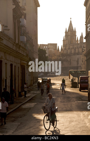 Backlit Cuban street scene with view towards cathedral. Havana, Cuba Stock Photo