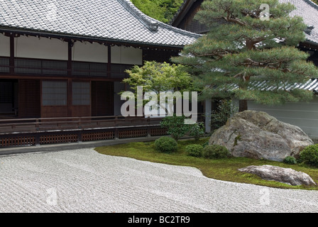 A stately pine tree and boulder form the focal point of this raked gravel dry landscape garden at Nanzenji Temple in Kyoto Stock Photo