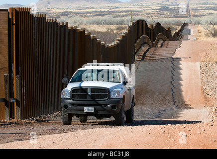 A US border patrol drives the new pedestrian fence on Mexican border, AZ. Stock Photo