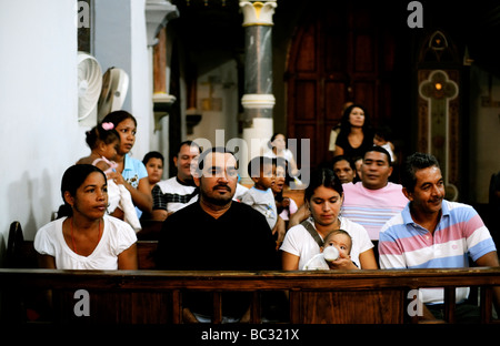 Latin American families attend mass on the Caribbean Island of Margarita in  Venezuela. Stock Photo