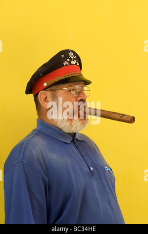 Cuban man posing as Ernest Hemingway with a cigar and cap. Old Havana, Cuba Stock Photo