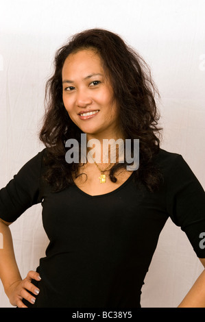 Asian woman with hands on hips Stock Photo - Alamy