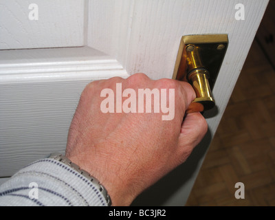 Male hand operating door handle Stock Photo