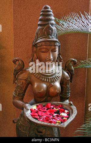 Brass Statue Of A Hindu Goddess Holding A Plate Of Flower Petal Offerings, Bhubaneshwar, Orissa, India Stock Photo