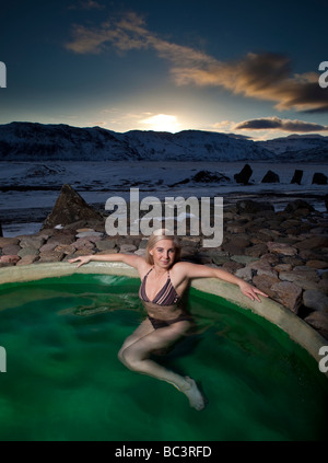 Young Woman in Geothermal Heated Hot Tub, Hornafjordur, Eastern Iceland Stock Photo