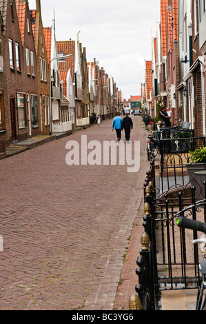 Street in Volendam with two pedestrians Stock Photo