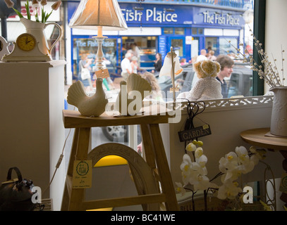 Interior of arts and crafts shop in the seaside town of Swanage, Dorset. UK. View of The Fish Plaice restaurant across the road. Stock Photo