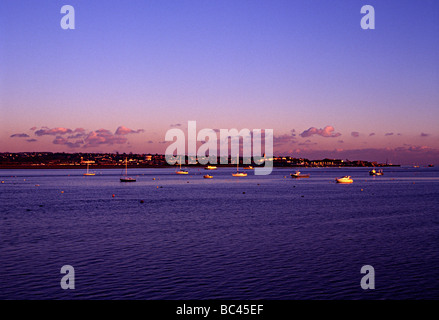 torbay estuary duing a sunset with sea boats in harbour shot from the railway Stock Photo