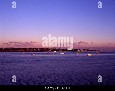 torbay estuary duing a sunset with sea boats in harbour shot from the railway Stock Photo