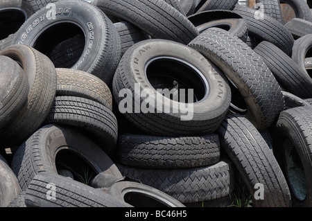 A pile of worn used tires sits in back of  an auto repair shop, Florida. Stock Photo