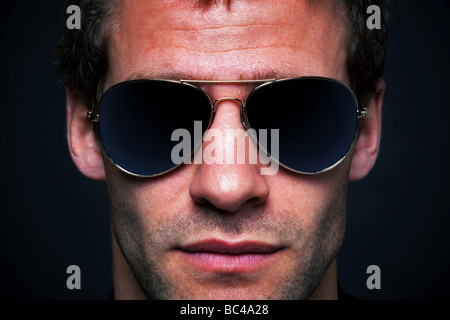 Close up portrait of a man wearing gold rimmed aviator sunglasses clipping path for the lenses to add your own reflection Stock Photo