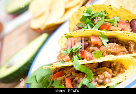 Tacos stuffed with beans meat salad and tomatoes Stock Photo