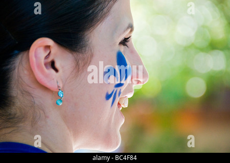 Fleur de lys symbol of the province of quebec on a face during the Saint Jean baptiste parade Montreal Stock Photo